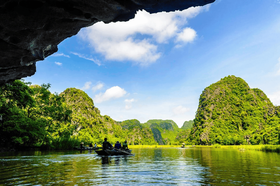 As you glide along crystal-clear rivers, you’ll pass through mysterious caverns, limestone valleys, and sacred temples (source: VNplus)